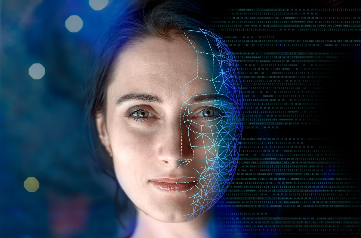 Close-up portrait of a woman's face partially overlaid with a blue digital grid and binary code on a dark background with bokeh lights.